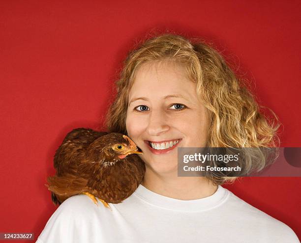 caucasian mid-adult woman with chicken on shoulder. - golden wyandottes stock pictures, royalty-free photos & images