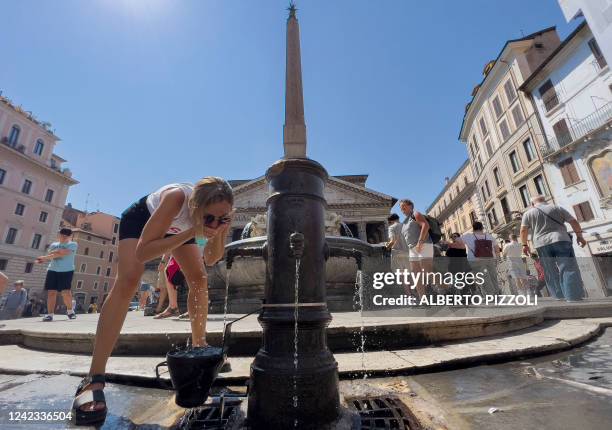 Woman cools off in a fountain in central Rome on August 6 amid a heatwave across southern Europe. Heatwaves have become more frequent due to climate...