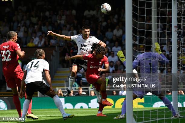 Fulham's Serbian striker Aleksandar Mitrovic heads home the opening goal of the English Premier League football match between Fulham and Liverpool at...