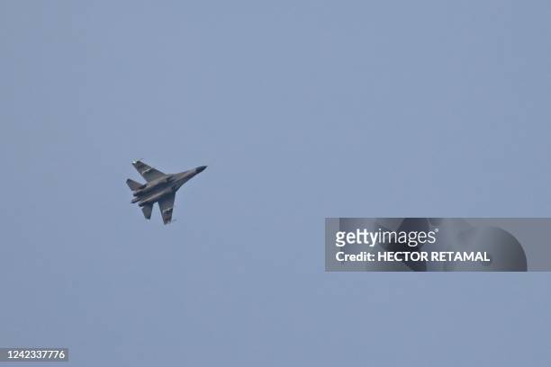 Chinese military jet flies over Pingtan island, one of mainland China's closest points to Taiwan, in Fujian province on August 6, 2022. - Taiwan...