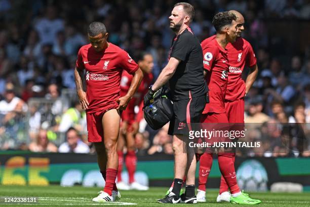 Liverpool's Spanish midfielder Thiago Alcantara leaves the game after picking up an injury during the English Premier League football match between...