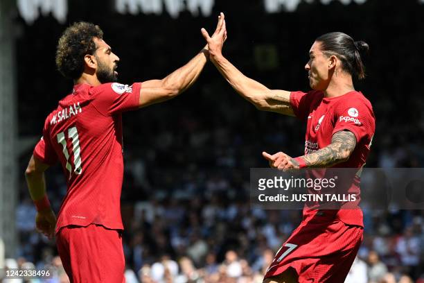 Liverpool's Uruguayan striker Darwin Nunez celebrates with Liverpool's Egyptian striker Mohamed Salah after scoring their first goal during the...