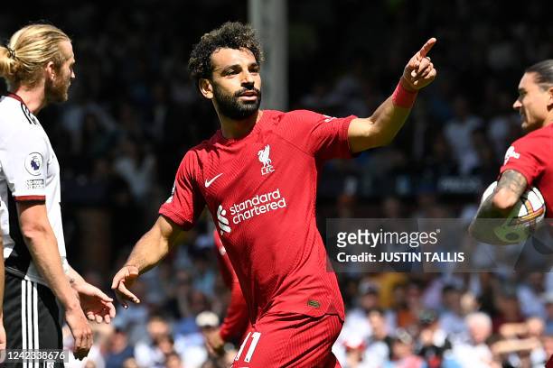 Liverpool's Egyptian striker Mohamed Salah celebrates after scoring their second goal during the English Premier League football match between Fulham...