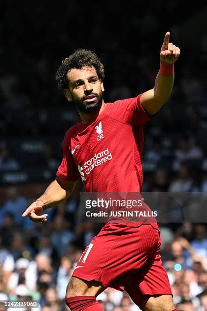 Liverpool's Egyptian striker Mohamed Salah celebrates after scoring their second goal during the English Premier League football match between Fulham...