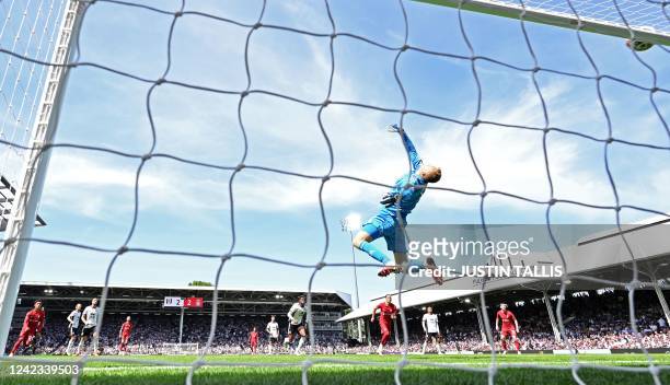Liverpool's English midfielder Jordan Henderson watches as his long-range shot comes back off the crossbar during the English Premier League football...