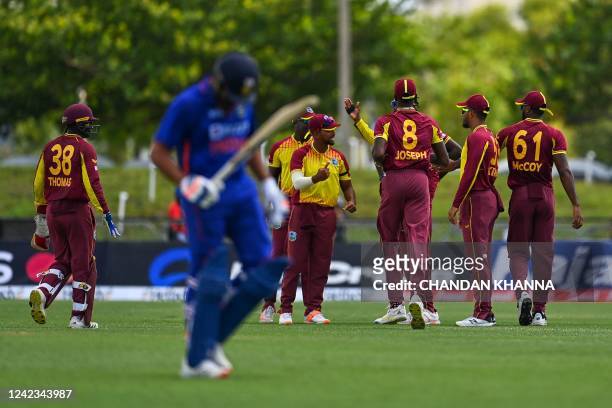 West Indies players celebrate after the dismissal of Rohit Sharma, of India, during the fourth T20I match between West Indies and India at the...