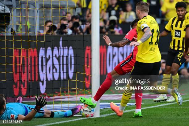 Dortmund's German forward Marco Reus helps the ball over the line to score the opening goal during the German first division Bundesliga football...