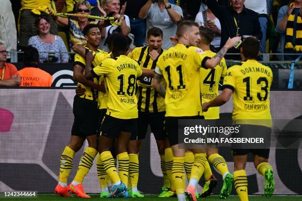 Dortmund's players celebrate scoring the opening goal during the German first division Bundesliga football match between BVB Borussia Dortmund and...
