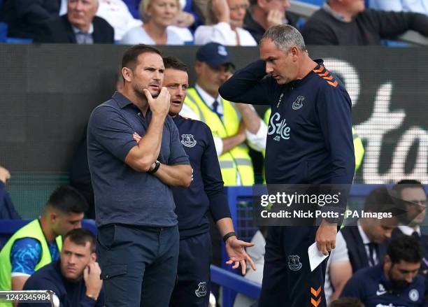 Everton manager Frank Lampard talks to assistant manager Joe Edwards and first-team coach Paul Clement after Yerry Mina leave the pitch with an...
