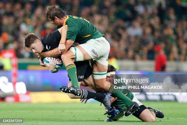 South Africa's lock Eben Etzebeth and South Africa's prop Frans Malherbe tackle New Zealand's fly-half Beauden Barrett during the Rugby Championship...