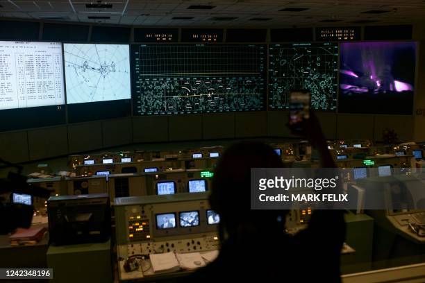 Person photographs the Apollo Flight Control Room at the Johnson Space Centers Mission Control Center in Houston, Texas, on August 5, 2022. - Rick...