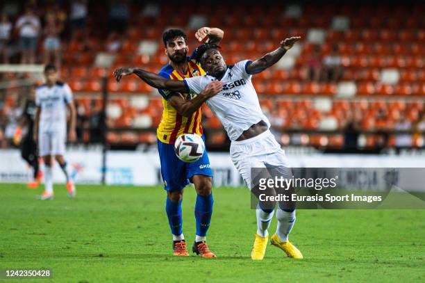 Eray Comert of Valencia CF battles for the ball with Duvan Zapata of Atalanta during the 50th Edition of Trofeu Toranja match between Valencia CF and...