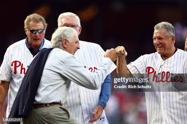 Former Philadelphia Phillies pitcher Ron Reed fist bumps Larry Bowa as Steve Carlton and Mike Schmidt look on before his induction into the Phillies...