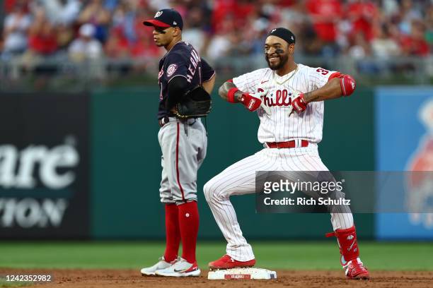 Edmundo Sosa of the Philadelphia Phillies gestures from second base after he hit an RBI double as second baseman Cesar Hernandez of the Washington...
