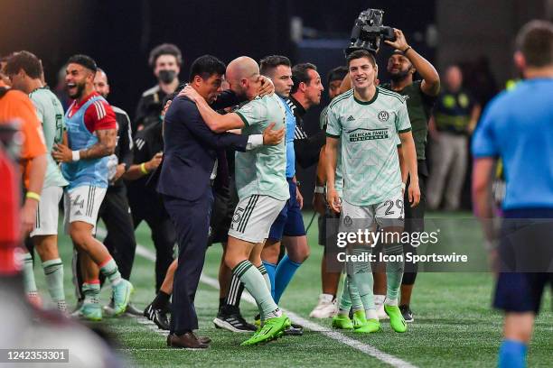 Atlanta defender Andrew Gutman embraces head coach Gonzalo Pineda after he scored the winning goal in stoppage time during the MLS match between...