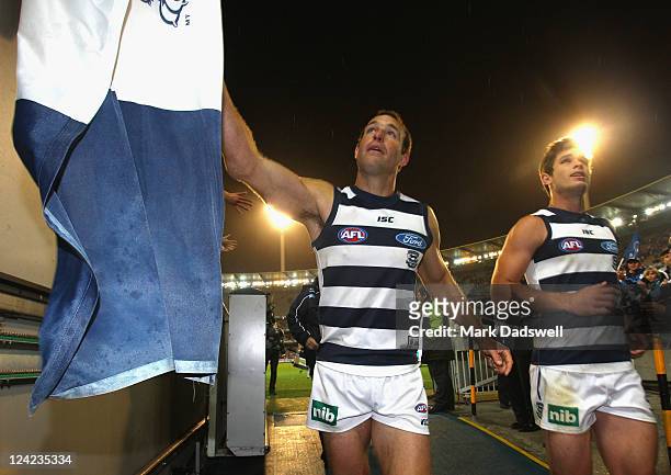 Brad Ottens and Tom Hawkins of the Cats celebrate with fans after their win over the Hawks in the AFL Second Qualifying match between the Geelong...