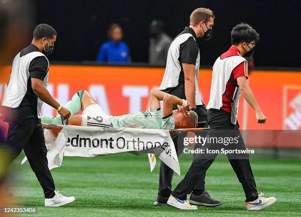 Atlanta midfielder Matheus Rossetto is carried off the pitch on a stretcher during the MLS match between Seattle Sounders FC and Atlanta United FC on...