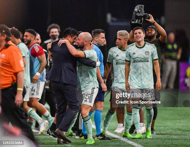 Atlanta defender Andrew Gutman embraces head coach Gonzalo Pineda after he scored the winning goal in stoppage time during the MLS match between...