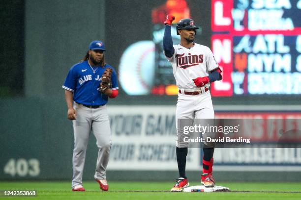 Byron Buxton of the Minnesota Twins celebrates his double as Vladimir Guerrero Jr. #27 of the Toronto Blue Jays looks on in the second inning of the...