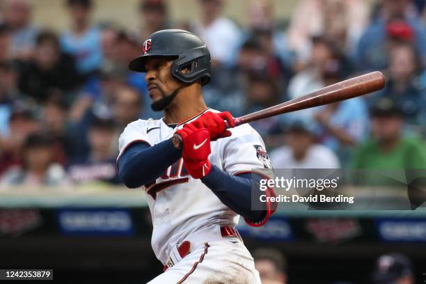 Byron Buxton of the Minnesota Twins hits a sacrifice ground out to score a run against the Toronto Blue Jays in the third inning of the game at...