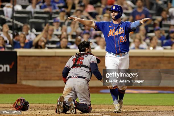 Pete Alonso of the New York Mets reacts after scoring a run past Travis d'Arnaud of the Atlanta Braves during the sixth inning in the second game of...