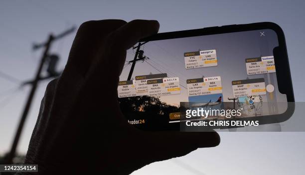 In this illustration photo, the Flightradar24 app shows, via augmented reality, the live position of planes in the area, on a smartphone in Los...
