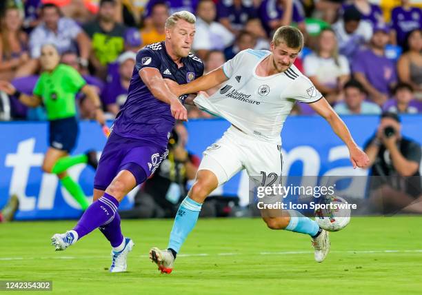 Orlando City defender Robin Jansson and New England Revolution forward Justin Rennicks fight for possession in the box Orlando City SC and New...