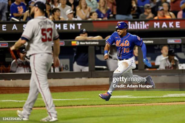 Eduardo Escobar of the New York Mets scores a run past Jackson Stephens of the Atlanta Braves during the eighth inning in the second game of a...