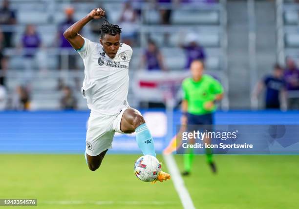New England Revolution forward DeJuan Jones saves the ball from going out during the MLS soccer match between the Orlando City SC and New England...