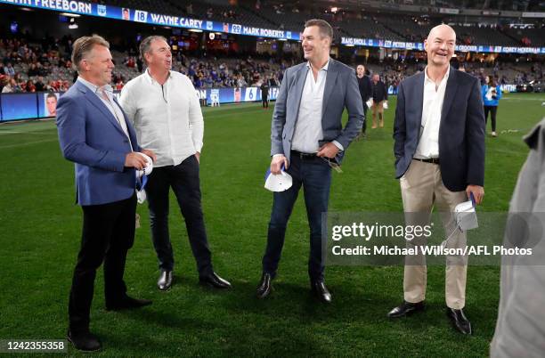 Glenn Archer, Craig Sholl, Wayne Carey and Darren Crocker chat during the 2022 AFL Round 21 match between the North Melbourne Kangaroos and the...