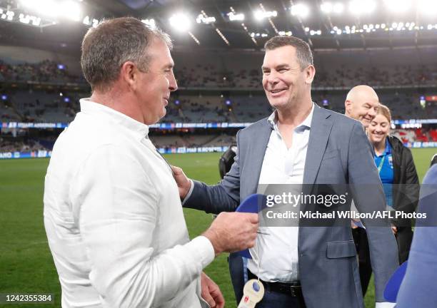 Wayne Carey and Craig Sholl chat during the 2022 AFL Round 21 match between the North Melbourne Kangaroos and the Sydney Swans at Marvel Stadium on...