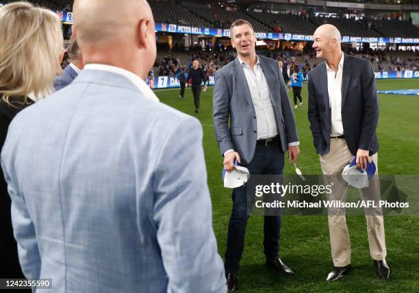 Wayne Carey and Darren Crocker are seen during the 2022 AFL Round 21 match between the North Melbourne Kangaroos and the Sydney Swans at Marvel...