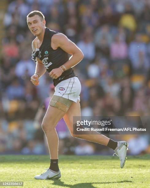Patrick Cripps of the Blues leaves the ground with a ripped jumper during the 2022 AFL Round 21 match between the Brisbane Lions and the Carlton...