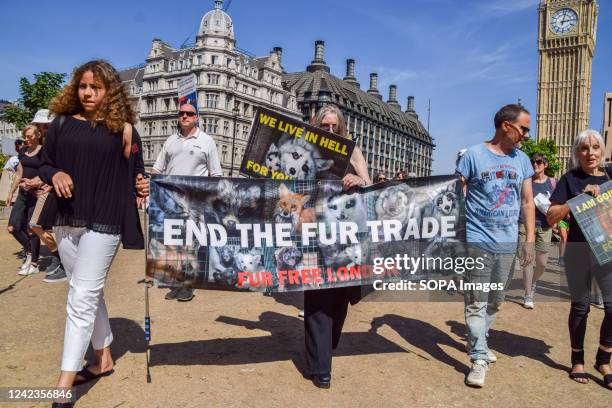 Protesters hold an anti-fur banner during the demonstration in Parliament Square. Thousands of people marched through central London in support of...