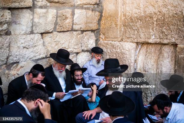 August 2022, Israel, Jerusalem: Jews pray at the Western Wall, known in Islam as the Buraq Wall, during the holy day Tisha B'Av, a day commemorating...