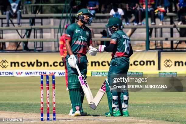 Bangladesh's Najmul Hossain Shanto and Bangladesh's Mushfiqur Rahim bump fists between overs during the second one-day international cricket match...