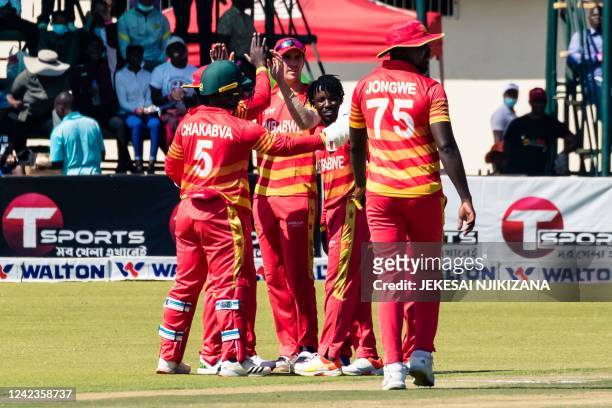 Zimbabwe's Wessly Madhevere celebrates with teammates after the dismissal of Bangladesh's Mushfiqur Rahim during the second one-day international...