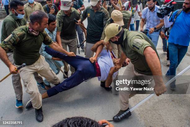 Indian police officers detain Kashmiri Shiite mourners trying to take part in a Muharram procession on August 7, 2022 in Srinagar, Indian...