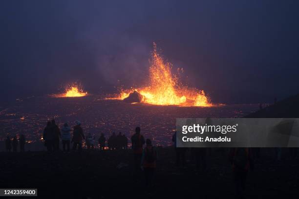 People visit the site of the newly erupted volcano taking place in Meradalir valley, near mount Fagradalsfjall outside the town of Grindavik, late on...