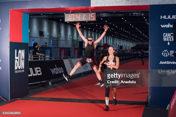 Athletes cross the finish line of the London Triathlon at the ExCeL Exhibition Centre organised by the LimeLight Sports Club in London, United...