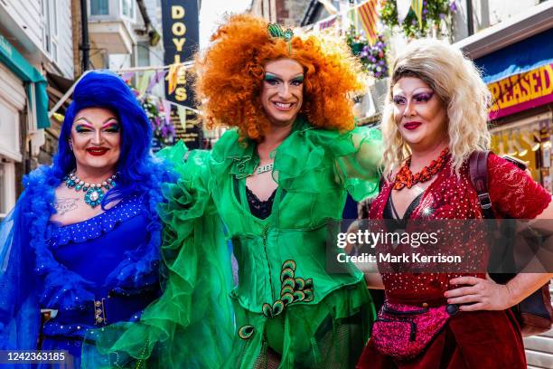 Brightly coloured revellers pause to pose in The Lanes during the 30th anniversary Brighton & Hove Pride LGBTQ+ Community Parade on 6th August 2022...