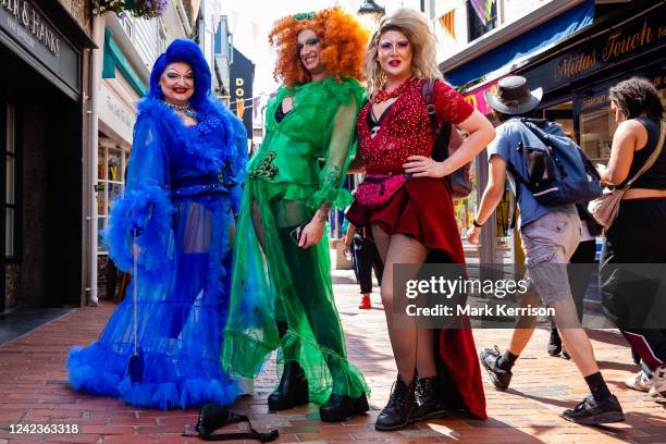 Brightly coloured revellers pause to pose in The Lanes during the 30th anniversary Brighton & Hove Pride LGBTQ+ Community Parade on 6th August 2022...