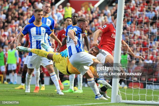 Brighton's Argentinian midfielder Alexis Mac Allister scores an own-goal past Brighton's Spanish goalkeeper Robert Sanchez during the English Premier...