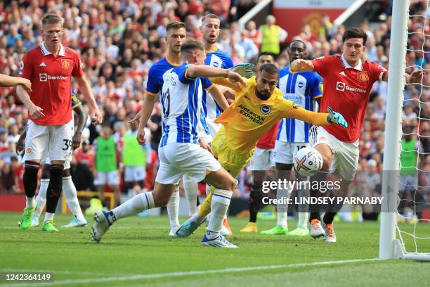 Brighton's Argentinian midfielder Alexis Mac Allister scores an own-goal past Brighton's Spanish goalkeeper Robert Sanchez during the English Premier...