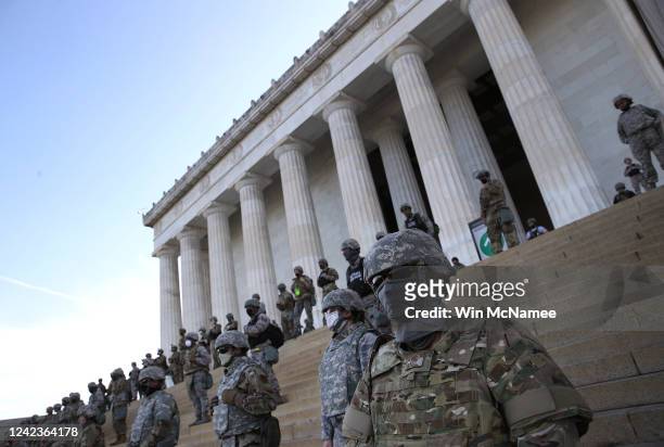 Members of the D.C. National Guard stand on the steps of the Lincoln Memorial as demonstrators participate in a peaceful protest against police...