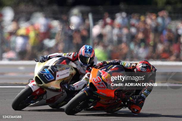 Red Bull KTM AJO's Spanish rider Augusto Fernandez and Idemitsu Honda Team Asia's Japanese rider Ai Ogura compete during the Moto2 race of the...