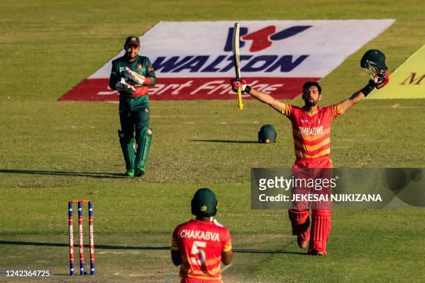 Zimbabwe's Sikandar Raza celebrates after scoring a century during the second one-day international cricket match between Zimbabwe and Bangladesh at...