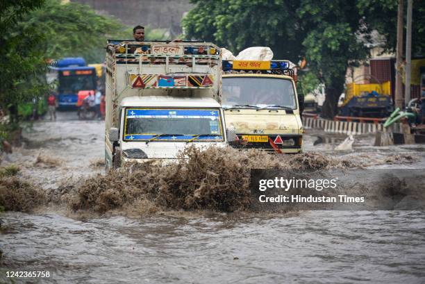 Vehicles wade through a heavily water logged street after sudden rains at Rohtak Road, on August 7, 2022 in New Delhi, India.