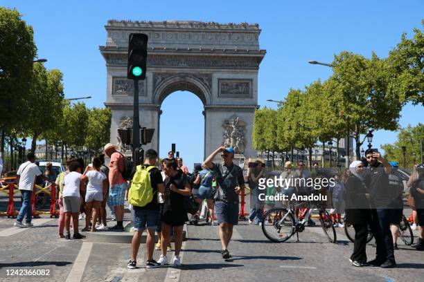 Pedestrians walk on Champs-Elysees Avenue, which is closed to traffic for the first sunday of every month for 7-8 hours, in Paris, France on August...