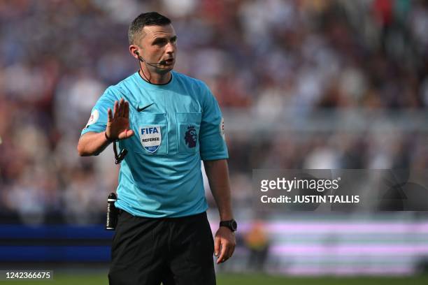 English referee Michael Oliver gestures during the English Premier League football match between West Ham United and Manchester City at the London...